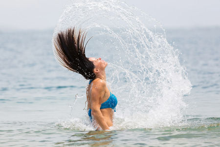 beautiful woman in water waving hairの写真素材