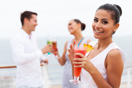 attractive girl holding a tropical cocktail on cruiseの写真素材