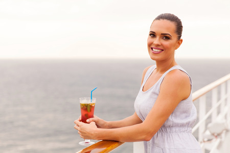 attractive woman relaxing on cruise ship deck with cocktailの写真素材