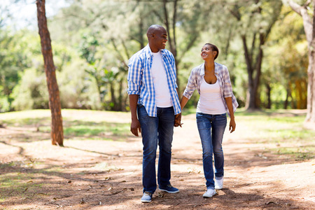happy african couple enjoying a walk at the parkの写真素材