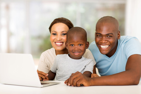 cheerful african family with laptop computerの写真素材