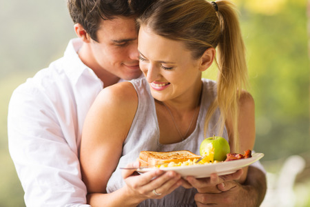 cute young couple flirting during breakfast timeの写真素材