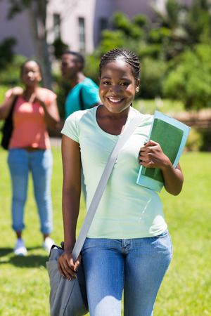 beautiful afro american university student with booksの写真素材