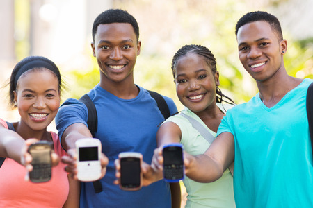 group african college students showing smart phonesの写真素材