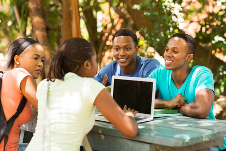 group of students using laptop computer on university campusの写真素材