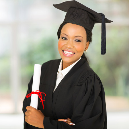 gorgeous female african university graduate looking at the cameraの写真素材