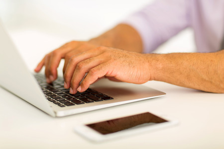 close up of man hands working on laptopの写真素材
