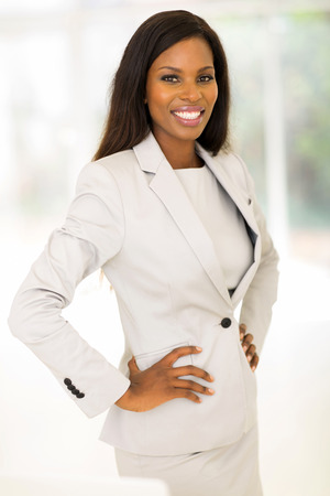 relaxed young corporate worker standing in officeの写真素材