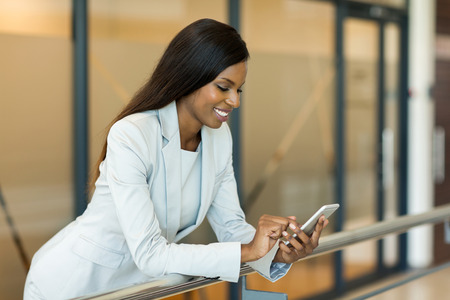 professional young african career woman using smart phoneの写真素材