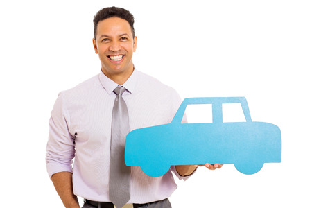 good looking businessman showing blue paper car on white backgroundの写真素材