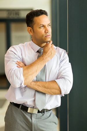 thoughtful businessman in modern officeの写真素材