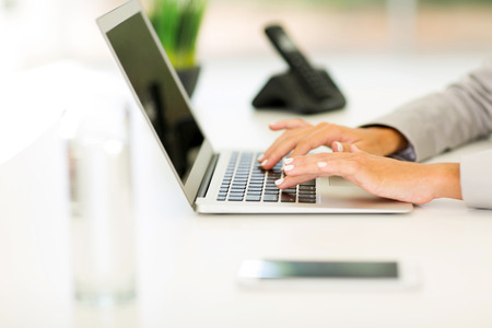 close up of female hands working on laptopの写真素材