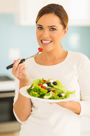 portrait of pretty woman eating saladの写真素材