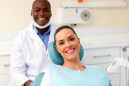 happy young patient in dentist officeの写真素材