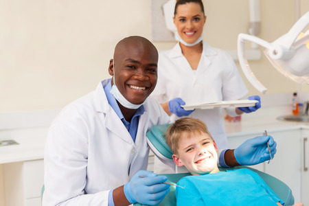 portrait of professional medical team and young patient during dental checkupの写真素材