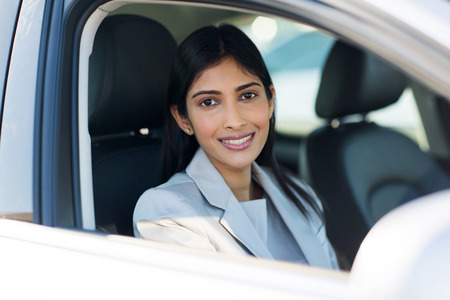 pretty indian woman inside a car