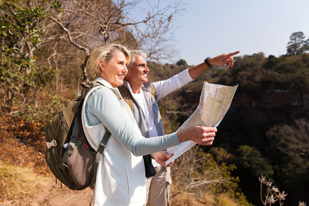 senior hiking couple on top of the mountain