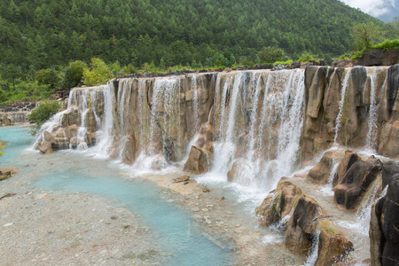 waterfall in Jade dragon snow mountain in Lijiang, Chinaの写真素材