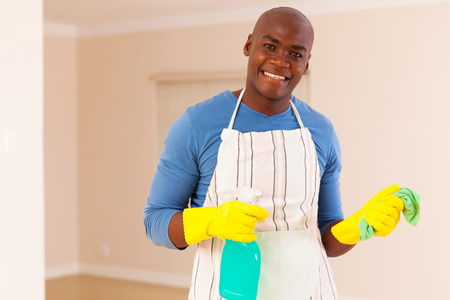 happy young african american man doing houseworkの写真素材