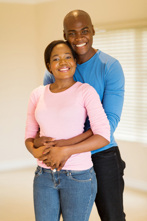 portrait of happy young african american couple in new homeの写真素材