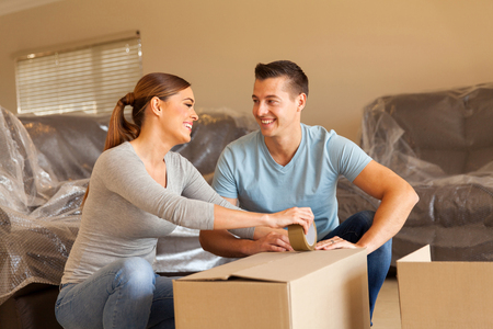 cheerful couple packing for new houseの写真素材
