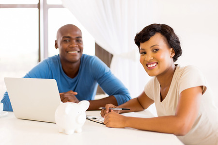 smart young african couple  doing their financials or paying billsの写真素材
