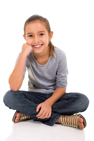 pretty little girl sitting on white backgroundの写真素材