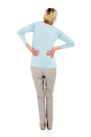 back view of senior woman having backache isolated on white backgroundの写真素材