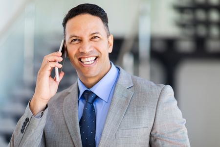 cheerful middle aged businessman talking on mobile phoneの写真素材