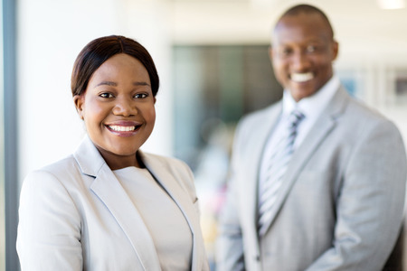 beautiful young african businesswoman standing in front of her colleagueの写真素材