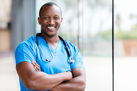 happy male african medical surgeon looking at the cameraの写真素材