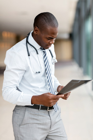 modern african american doctor looking at x-ray in officeの写真素材