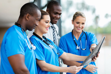 group of medical workers looking at patient's x-rayの写真素材