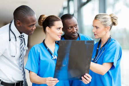 group of professional medical workers discussing patient's x-rayの写真素材