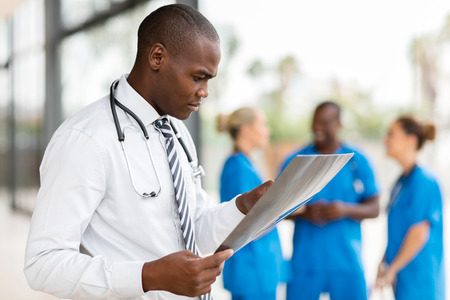 professional african medical worker looking at patient's x-ray at hospitalの写真素材