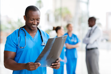 handsome african healthcare worker with x-rayの写真素材
