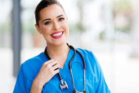pretty female healthcare worker closeup portrait in officeの写真素材