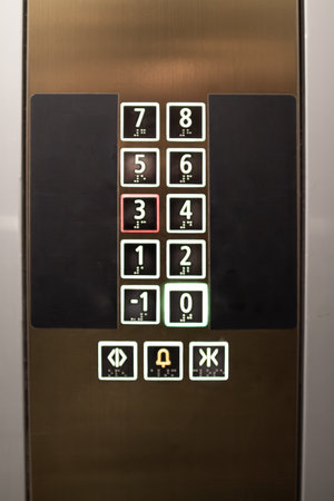 Elevator control panel displaying floor numbers and buttons in a modern building