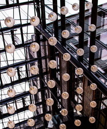 Modern light installations create a stunning visual effect in an urban indoor space during daylight...