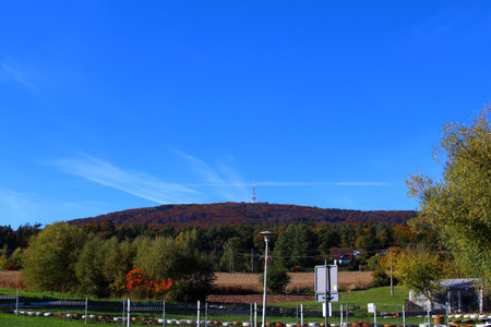 Scenic view of a mountain under a clear blue sky with autumn foliageの写真素材