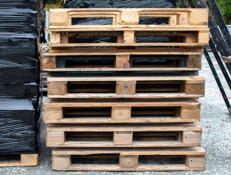Wooden pallets stacked in a warehouse ready for distribution and transportの写真素材