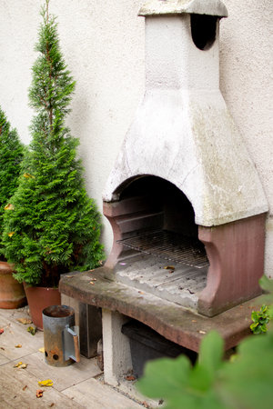 Outdoor masonry grill near thriving greenery in a cozy garden spaceの写真素材