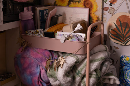 Colorful storage cart with blankets and supplies in a cozy room