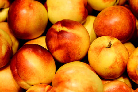 Pile of fresh peaches - background