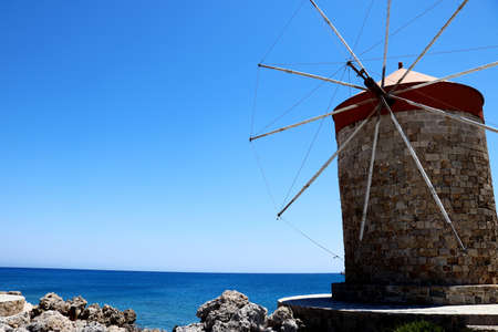 Windmill of Mandraki harbor in Greeceの写真素材