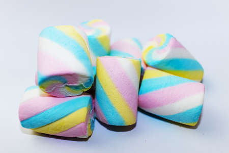 Closeup of heap of colorful marshmallows candy on a white backgroundの写真素材
