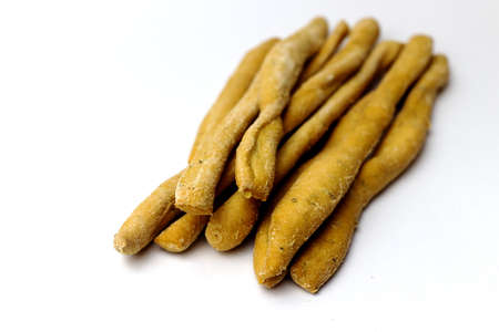 Heap of Italian breadsticks grissini on a white background - started in Italian cuisine