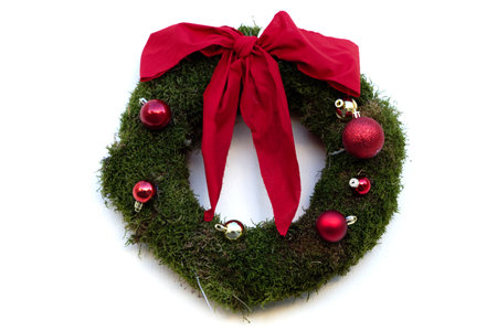 Minimalistic Christmas wreath with red ribbon on a white backgroundの写真素材
