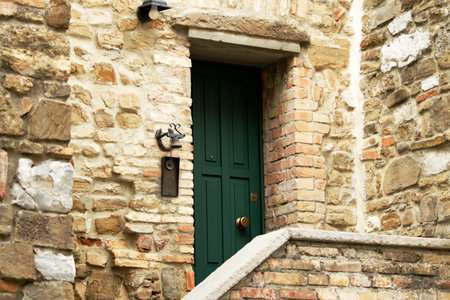Green wooden doors of an old stone mediterranean houseの写真素材