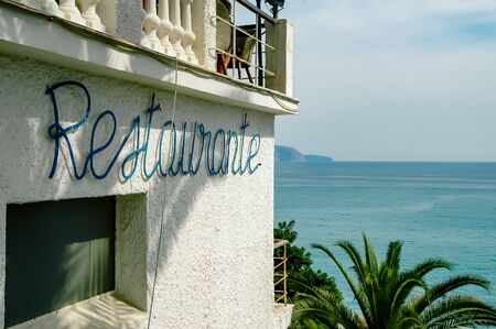 Crete, Greece - October 1, 2017: Sea facing restaurant with Mediterranean in backgroundのeditorial素材